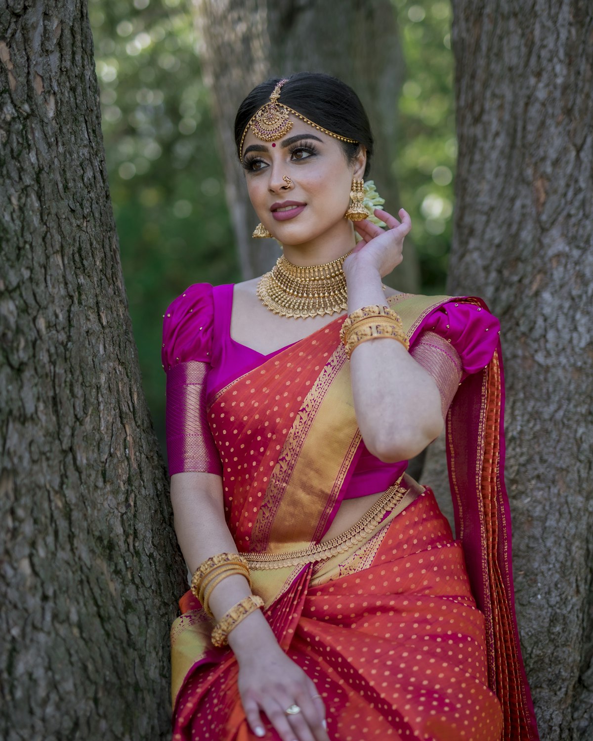 Woman in a red and blue saree styled for a celebration